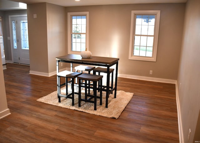 dining space with dark hardwood / wood-style flooring