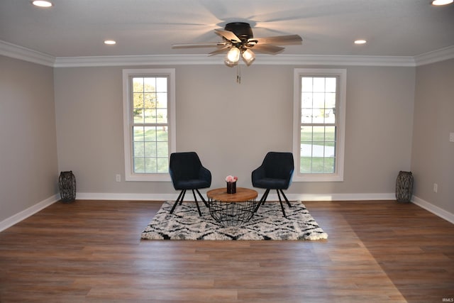 living area featuring ornamental molding, dark hardwood / wood-style floors, and ceiling fan