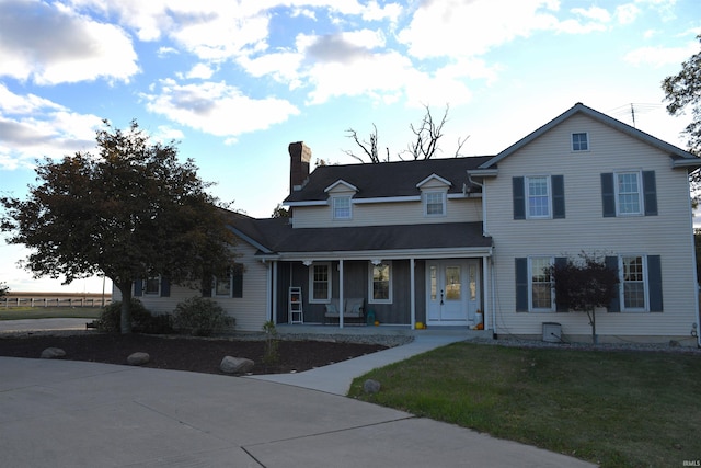 view of front of property with a porch and a front yard