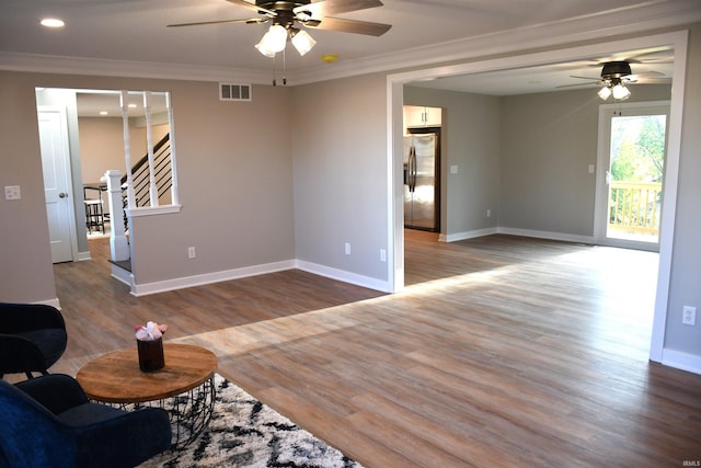 unfurnished living room featuring crown molding, hardwood / wood-style flooring, and ceiling fan