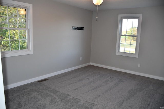 carpeted empty room featuring ceiling fan