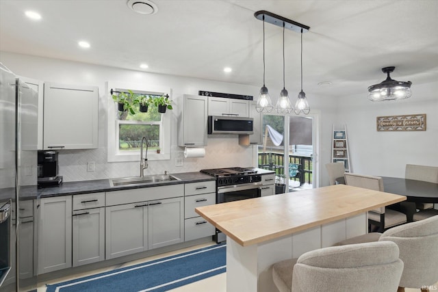 kitchen with gray cabinets, sink, stainless steel appliances, and plenty of natural light