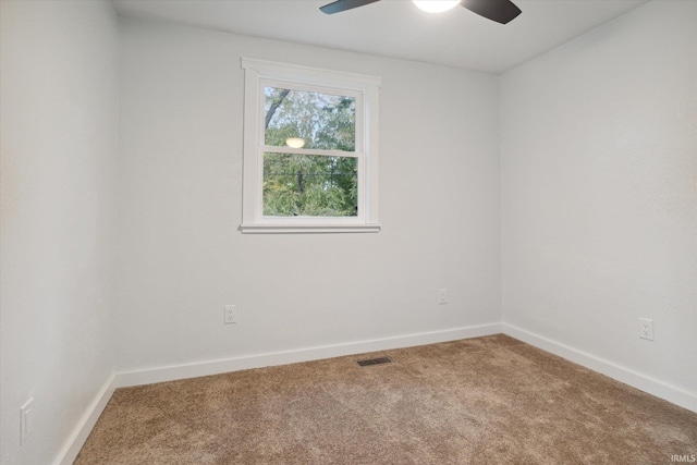 empty room with ceiling fan and carpet floors