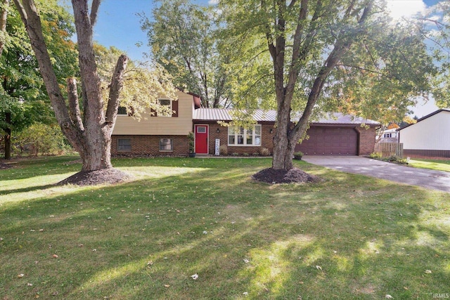 split level home with a front yard and a garage