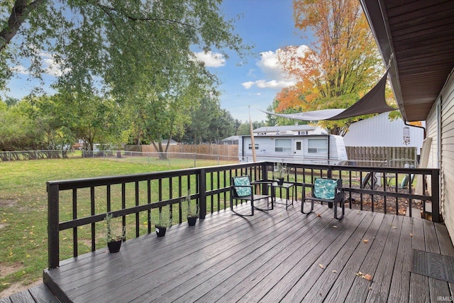 deck with a yard and a storage unit