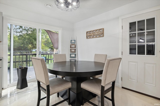 dining area featuring an inviting chandelier