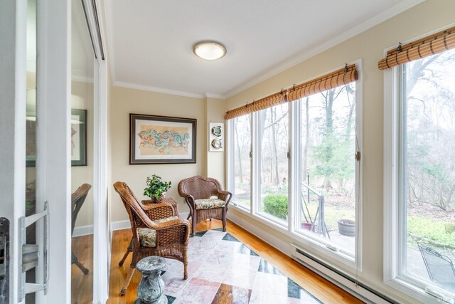 sunroom / solarium featuring a healthy amount of sunlight and a baseboard heating unit