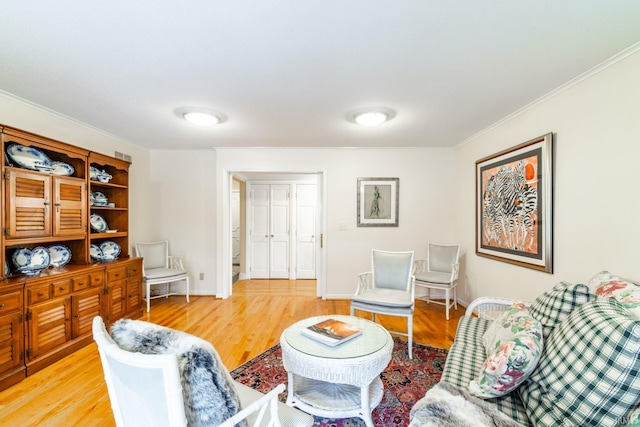 living room featuring crown molding and wood-type flooring