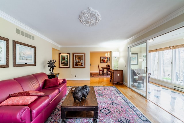 living room featuring light hardwood / wood-style floors, crown molding, and baseboard heating