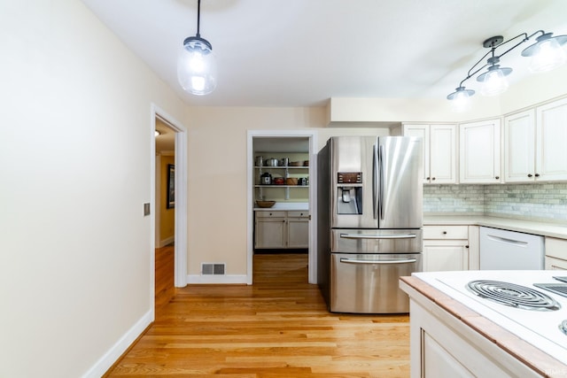 kitchen featuring light hardwood / wood-style flooring, hanging light fixtures, stainless steel refrigerator with ice dispenser, backsplash, and white cabinets