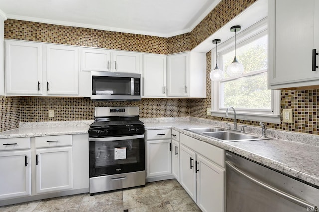 kitchen with hanging light fixtures, stainless steel appliances, sink, white cabinets, and tasteful backsplash