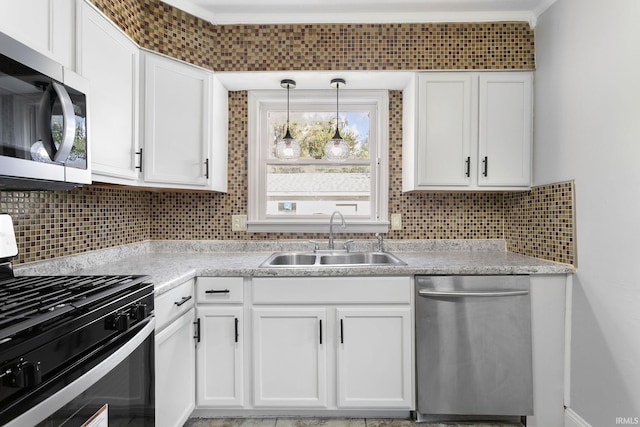 kitchen with sink, white cabinetry, stainless steel appliances, and tasteful backsplash