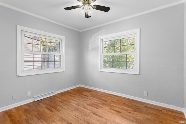 spare room featuring crown molding, light hardwood / wood-style floors, a healthy amount of sunlight, and ceiling fan