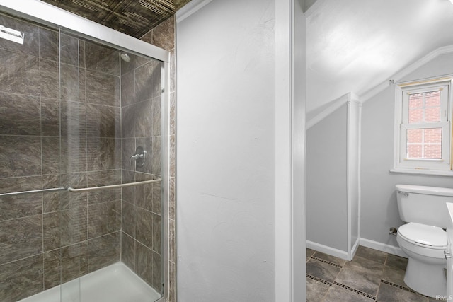 bathroom featuring toilet, lofted ceiling, ornamental molding, and walk in shower