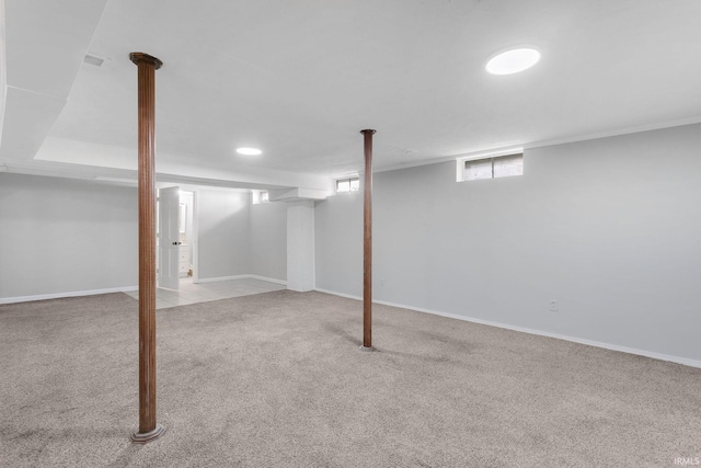 basement featuring light carpet