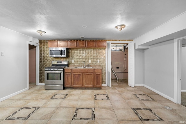 kitchen featuring sink, stainless steel appliances, a textured ceiling, and tasteful backsplash