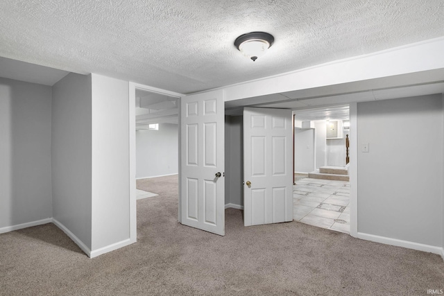 basement with light carpet and a textured ceiling