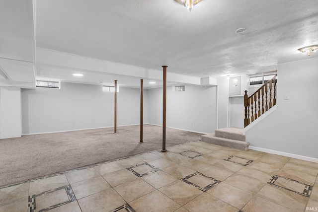 basement with light carpet and a textured ceiling