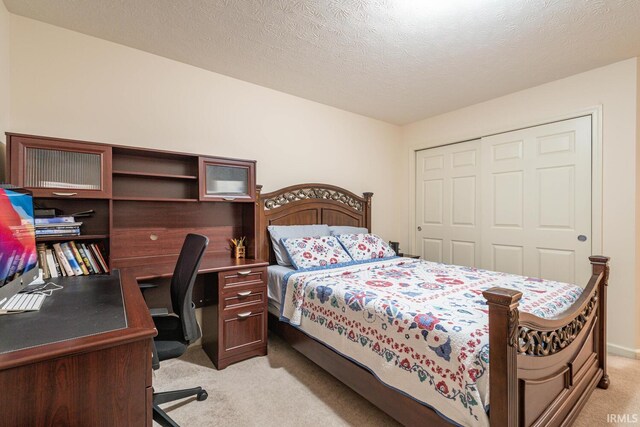 carpeted bedroom featuring a closet and a textured ceiling