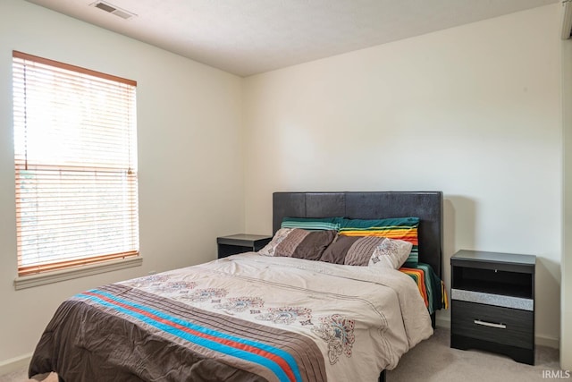 carpeted bedroom featuring multiple windows