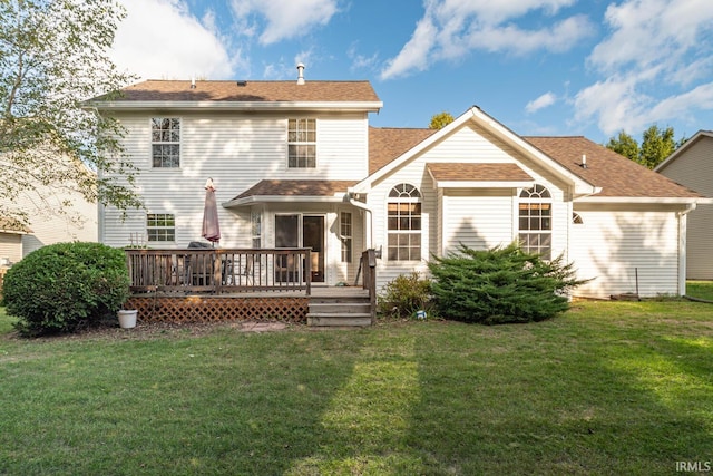rear view of property with roof with shingles, a yard, and a deck