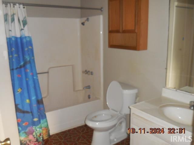 full bathroom featuring toilet, shower / bath combo, vanity, and tile patterned flooring