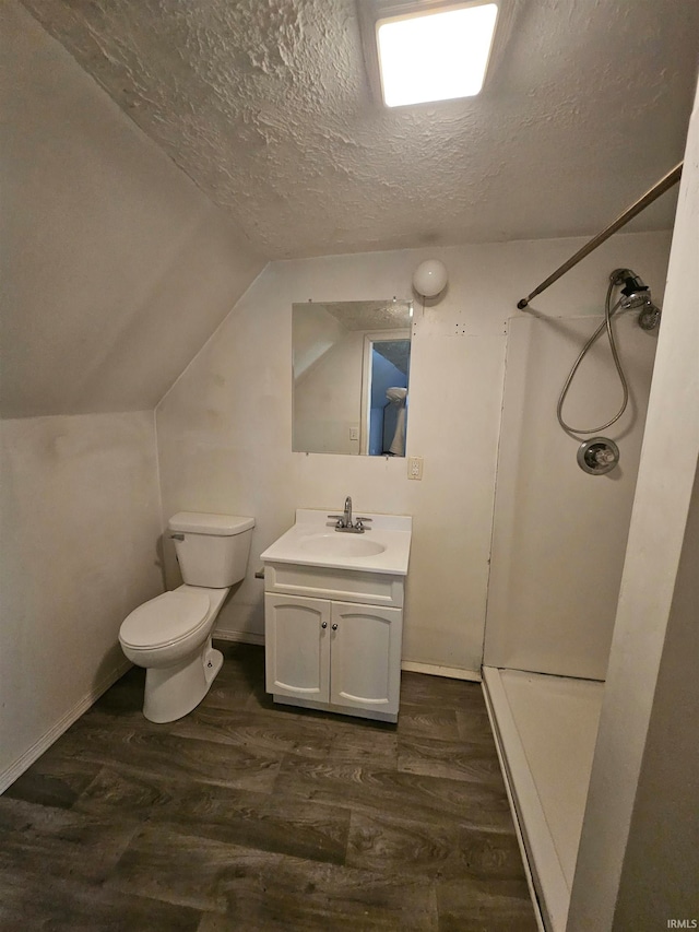 bathroom featuring wood-type flooring, a shower, and a textured ceiling