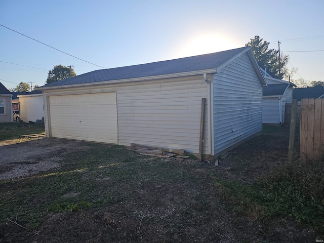 view of garage at dusk