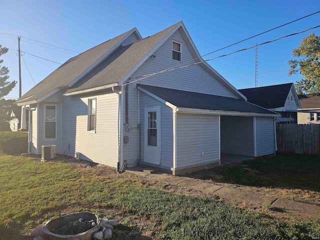 view of home's exterior featuring central AC unit and a lawn