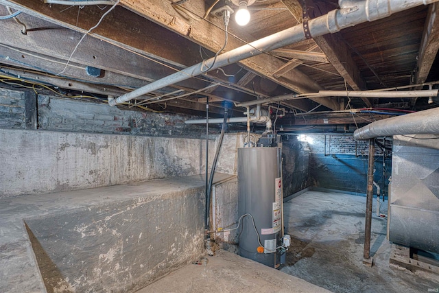 basement featuring gas water heater and heating unit