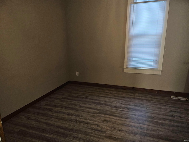 unfurnished room with dark hardwood / wood-style floors