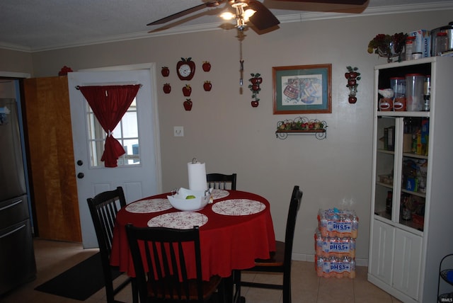 dining room with ornamental molding, light tile patterned flooring, and ceiling fan