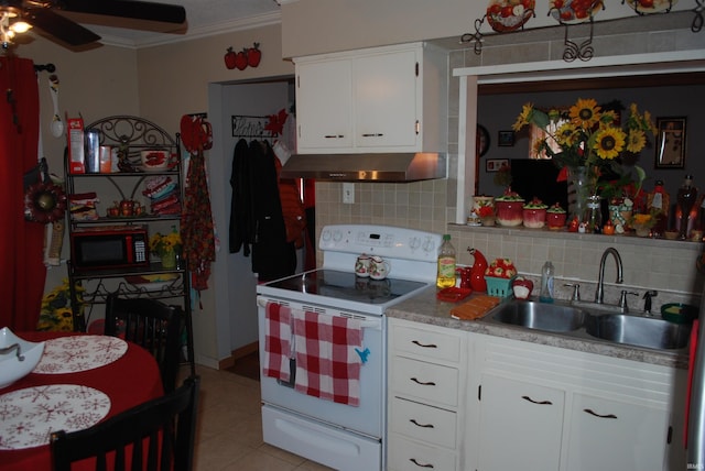 kitchen featuring light tile patterned flooring, sink, white cabinetry, white electric range, and decorative backsplash