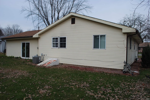 rear view of property featuring a yard