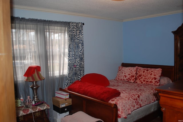 bedroom with ornamental molding, multiple windows, and a textured ceiling