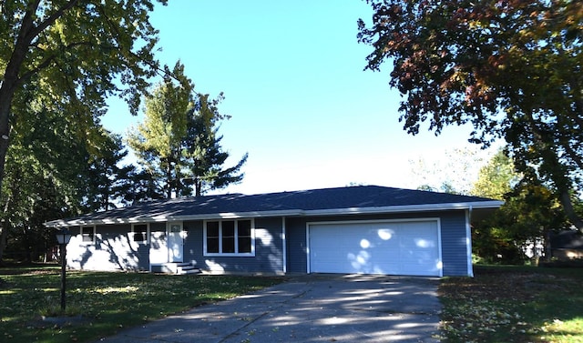 ranch-style home with a front lawn and a garage