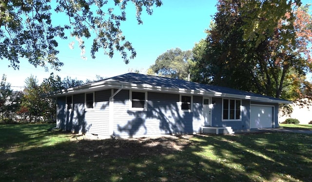 exterior space with a lawn and a garage