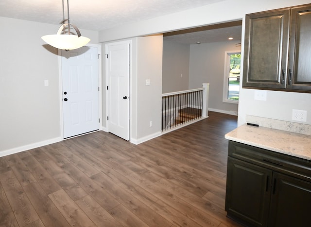 interior space with a textured ceiling and dark hardwood / wood-style flooring