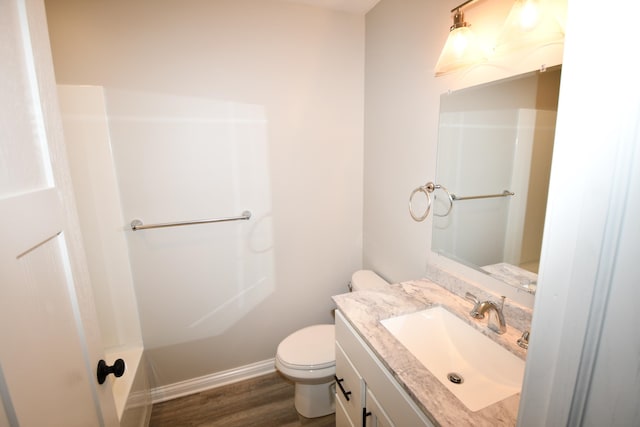 full bathroom with toilet, hardwood / wood-style flooring, vanity, and separate shower and tub