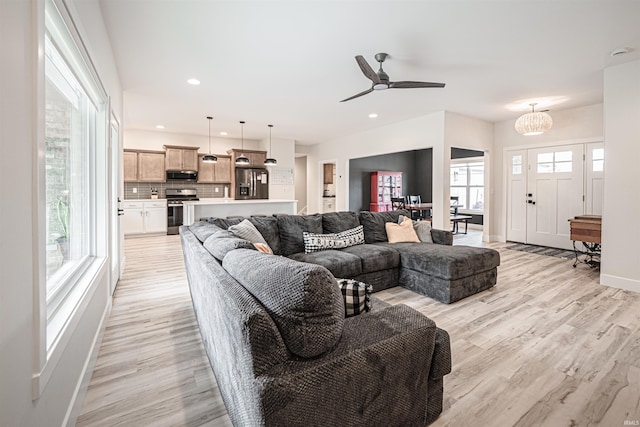 living room with light hardwood / wood-style floors and ceiling fan