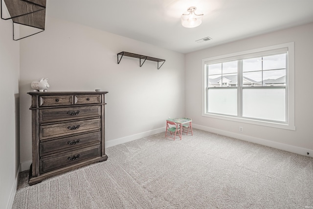 recreation room with light colored carpet