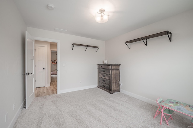 bedroom featuring light carpet