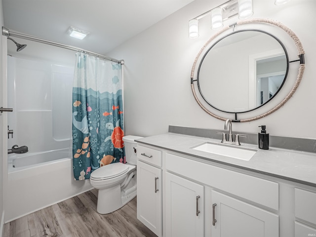 full bathroom featuring shower / bath combo with shower curtain, hardwood / wood-style floors, vanity, and toilet