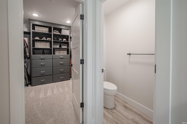 bathroom featuring hardwood / wood-style flooring and toilet