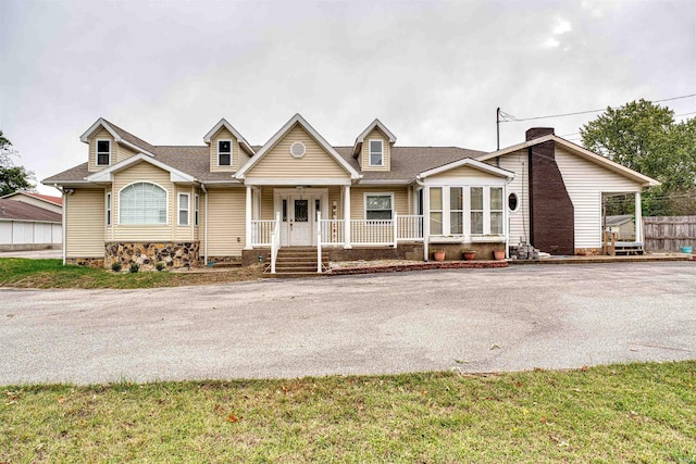 view of front of home with a front yard and a porch