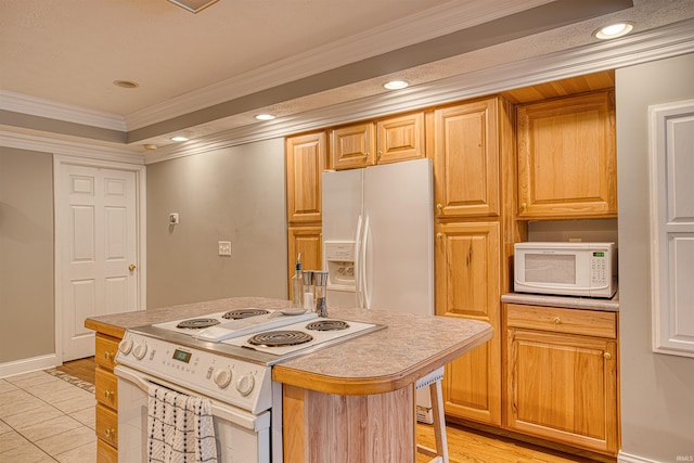 kitchen featuring a kitchen island with sink, ornamental molding, a kitchen bar, light wood-type flooring, and white appliances