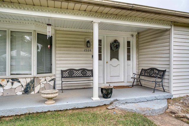 view of exterior entry with covered porch