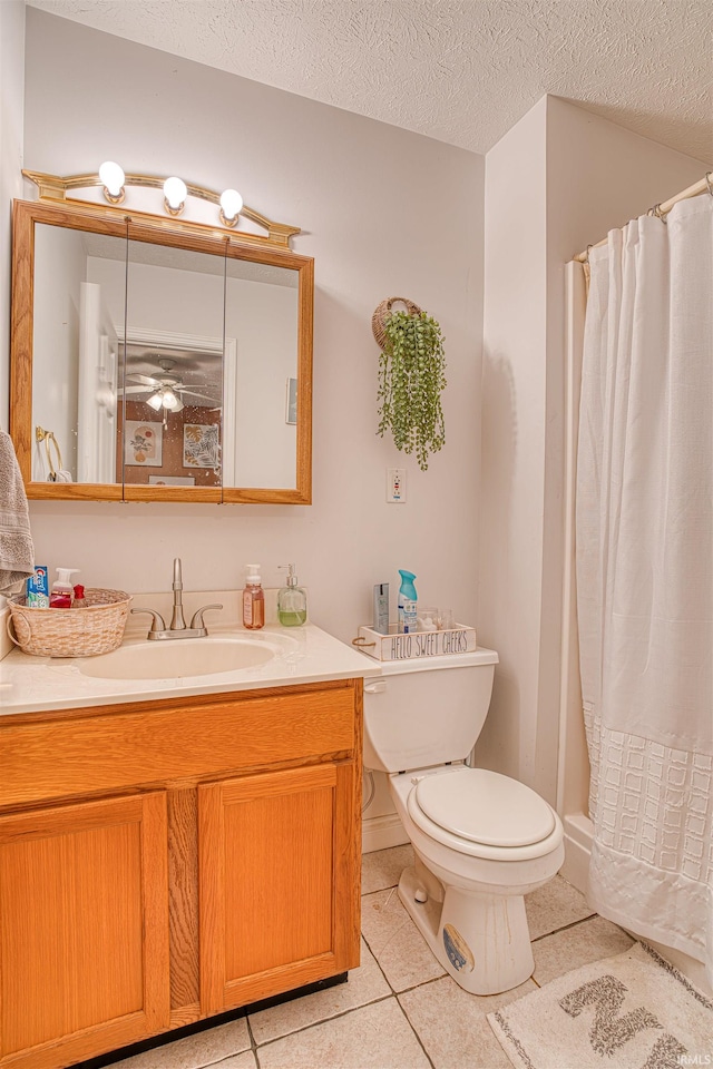 bathroom with a textured ceiling, toilet, vanity, a shower with curtain, and tile patterned flooring