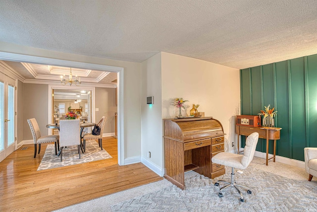 office space with a notable chandelier, ornamental molding, hardwood / wood-style flooring, and a textured ceiling