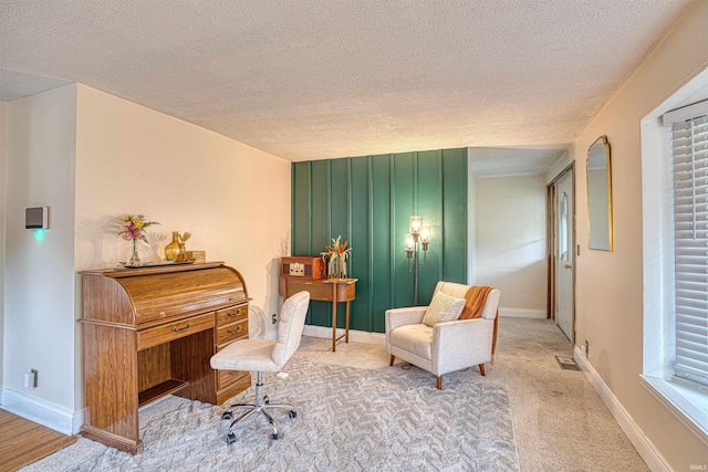 sitting room featuring a textured ceiling and carpet floors